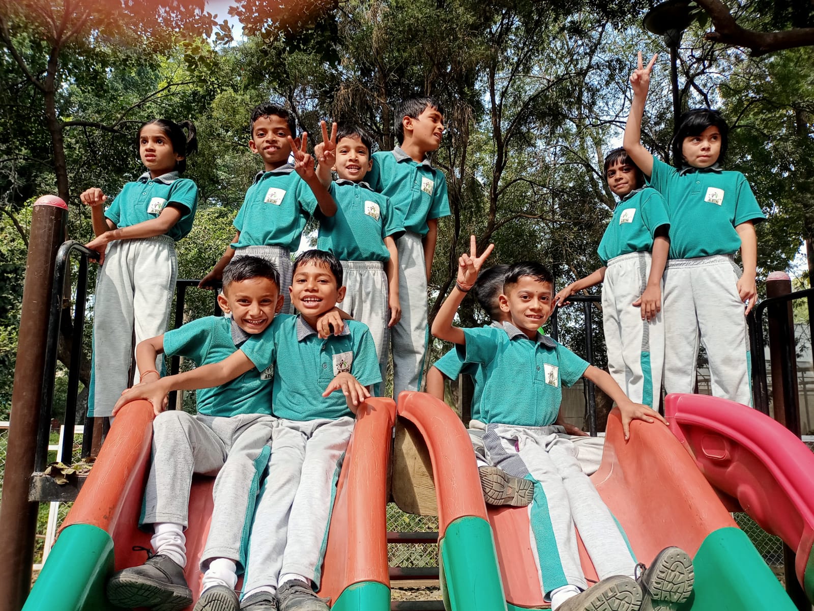 Kids enjoying the playground slides at school